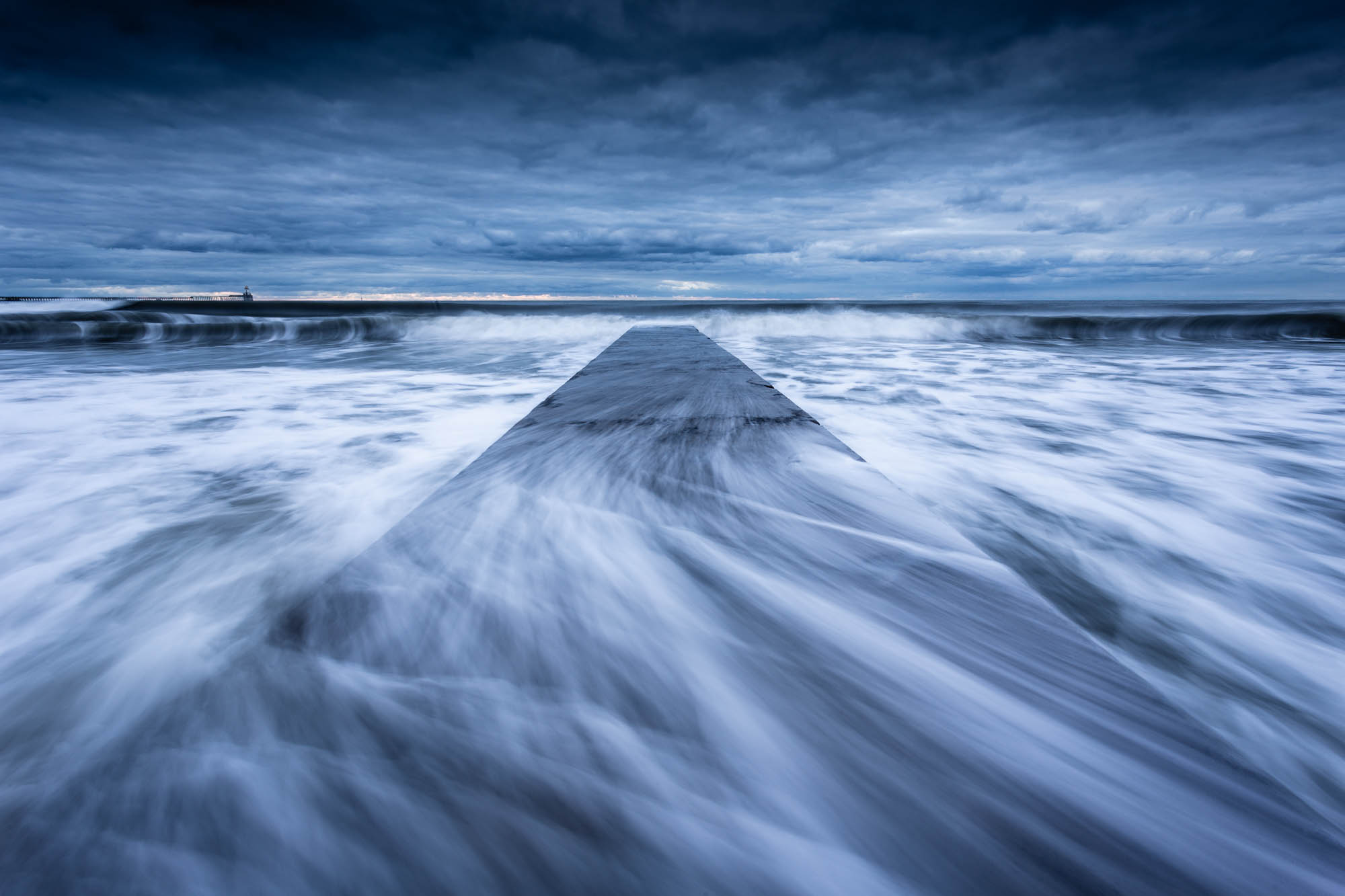 Waves sweep across the concrete jetty at Blyth Beach on the Northumberland coast. Enhanced with Photoshop's new Super Resolution feature.