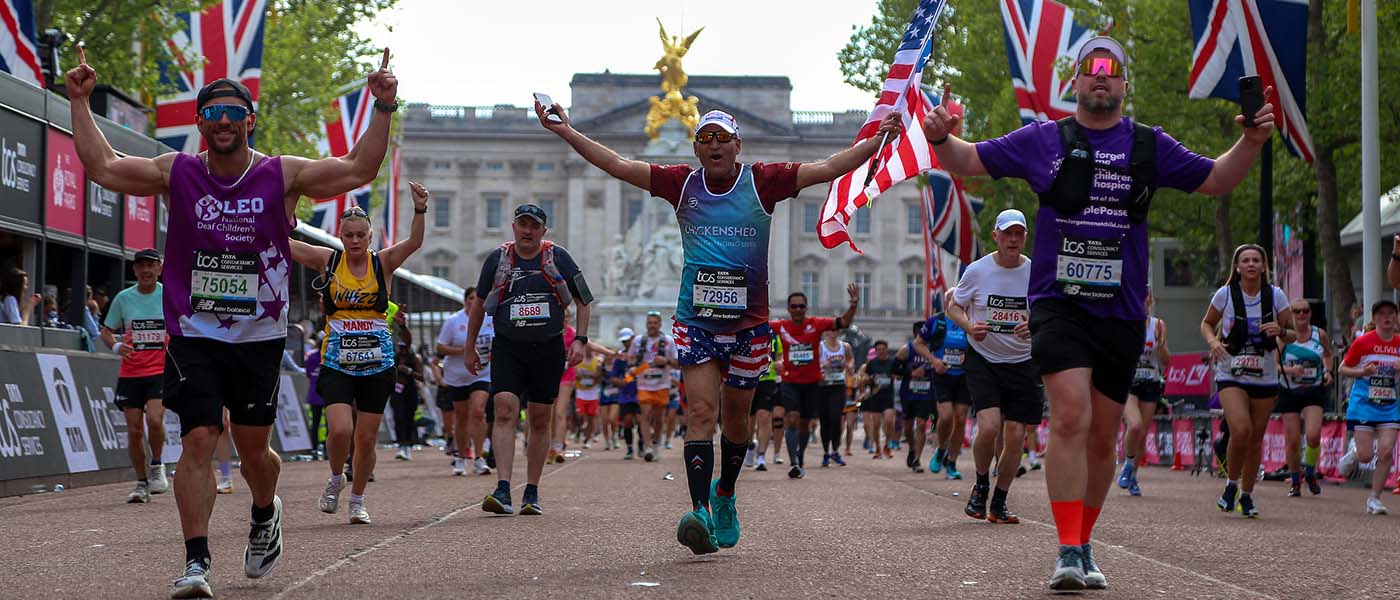 Runners complete the TCS London Marathon with Buckingham Palace in the background