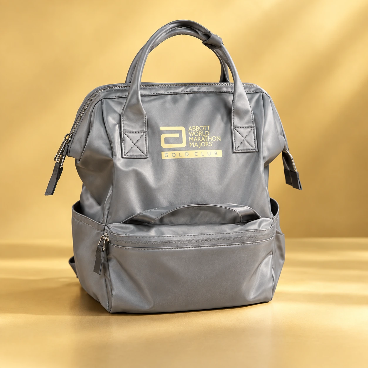Grey Gold Club backpack with the Abbott World Marathon Majors logo