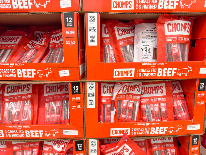Packages of Chomps beef sticks displayed at a grocery store.
