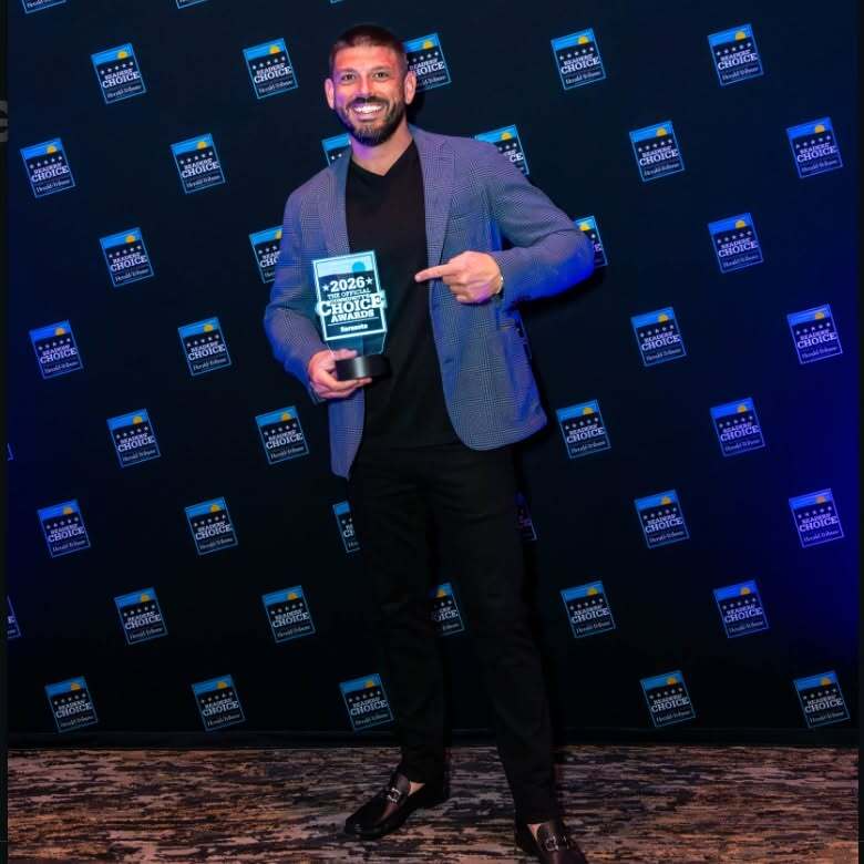 Blake proudly holding a community award