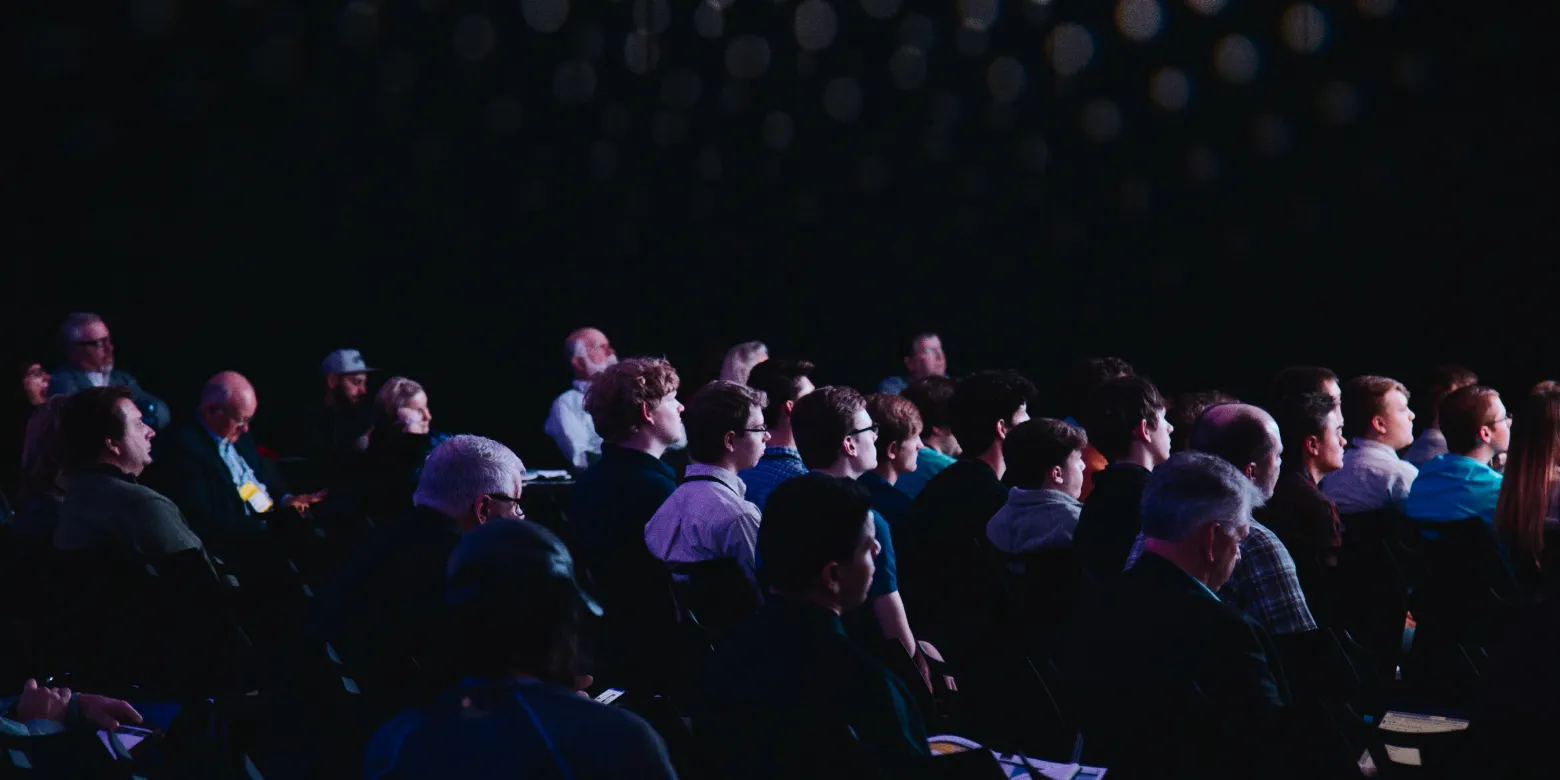 Audience listening to person on stage.