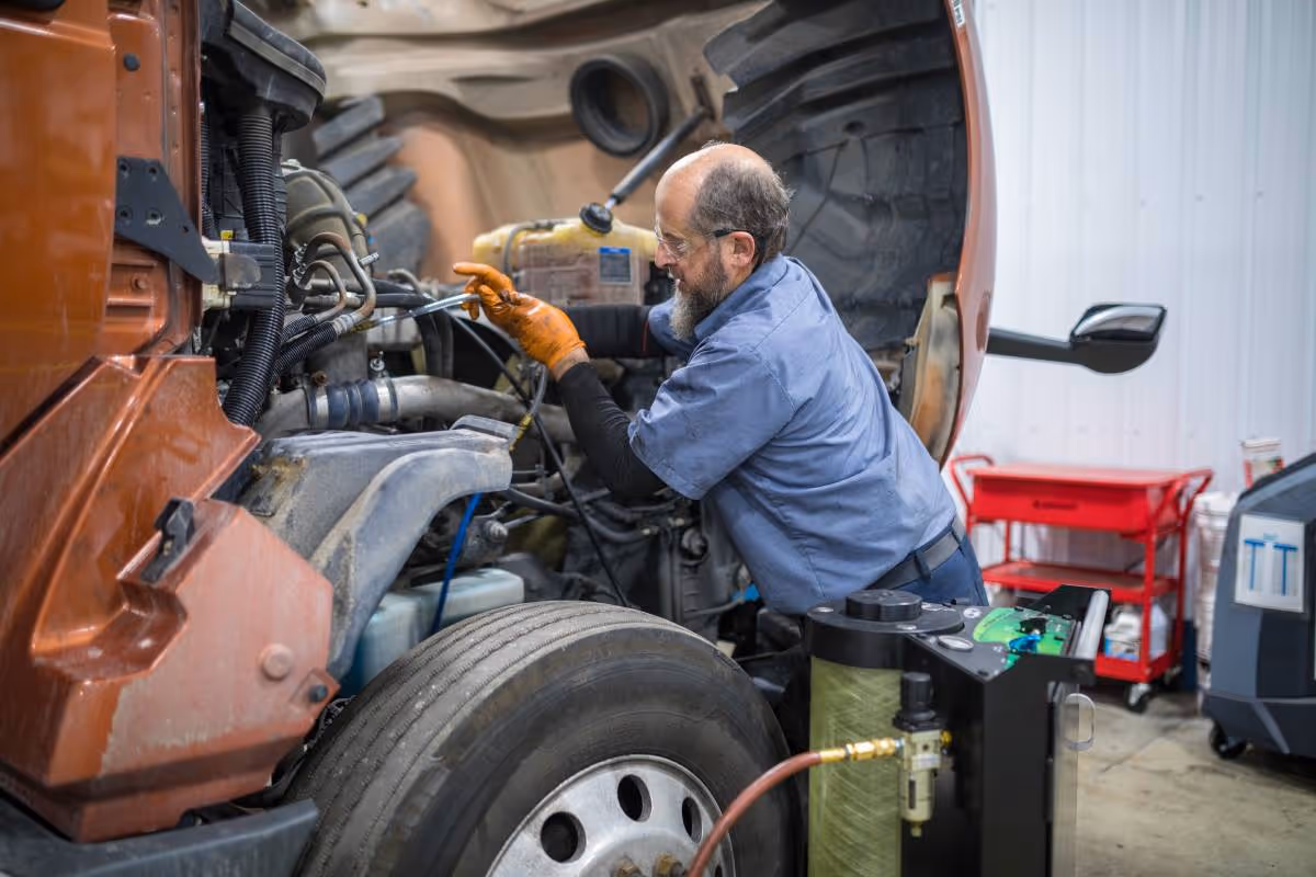 Diesel mechanic repairing diesel engine of semi truck