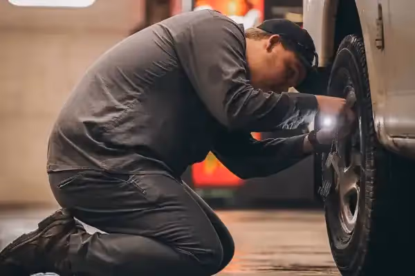 Mechanic performing truck repair in repair shop