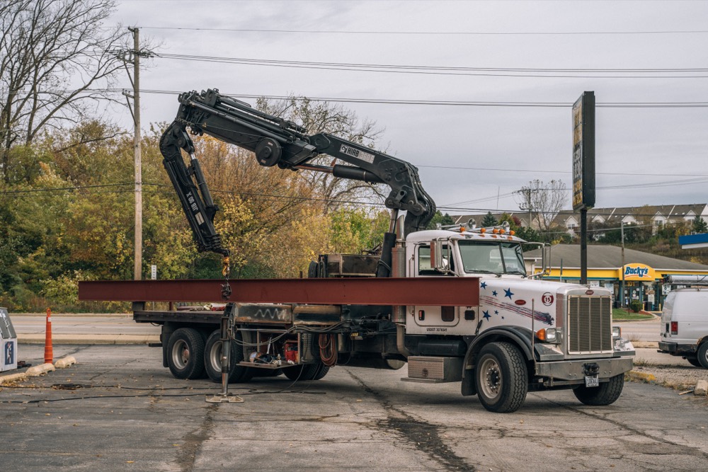 Adams Steel knuckleboom crane setting steel