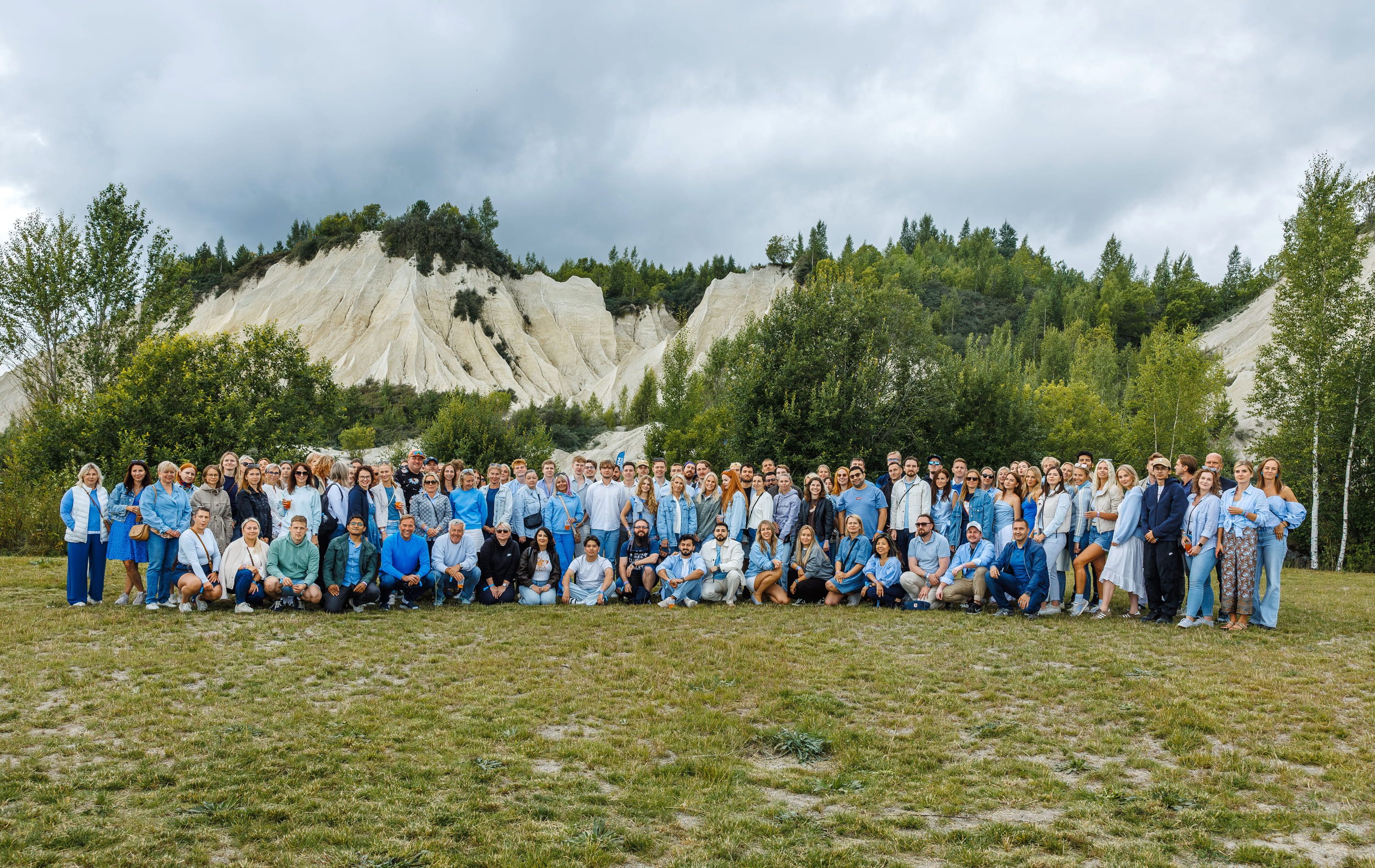The Inbank team in a large group photo outdoors in front of white cliffs