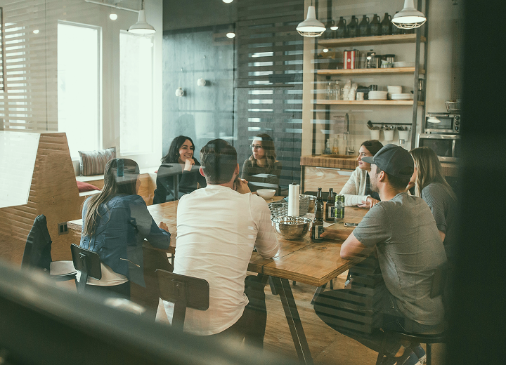 Startup company discussing recruitment with a recruitment agency behind a kitchen table