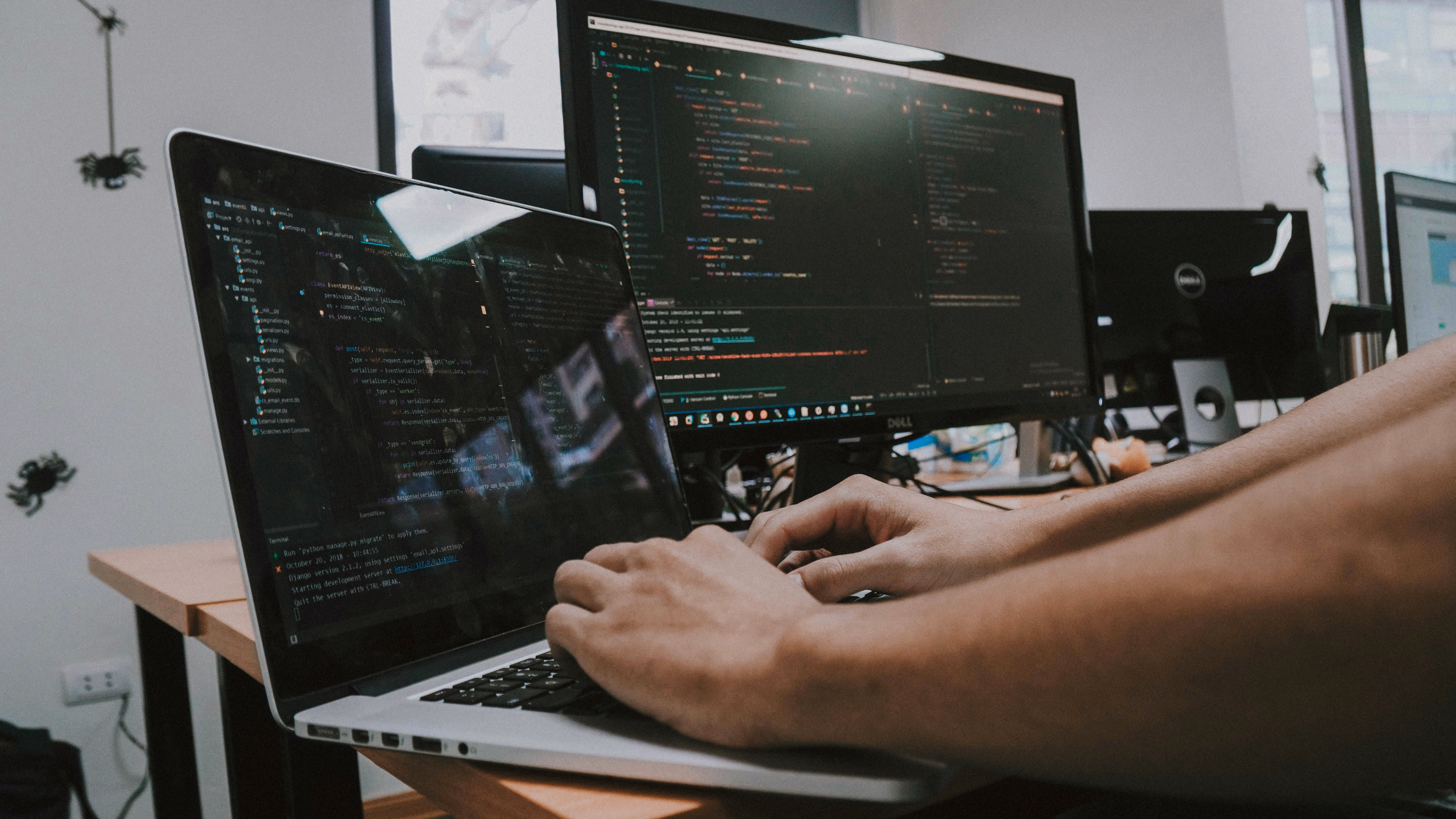 Software engineer working behind a laptop.