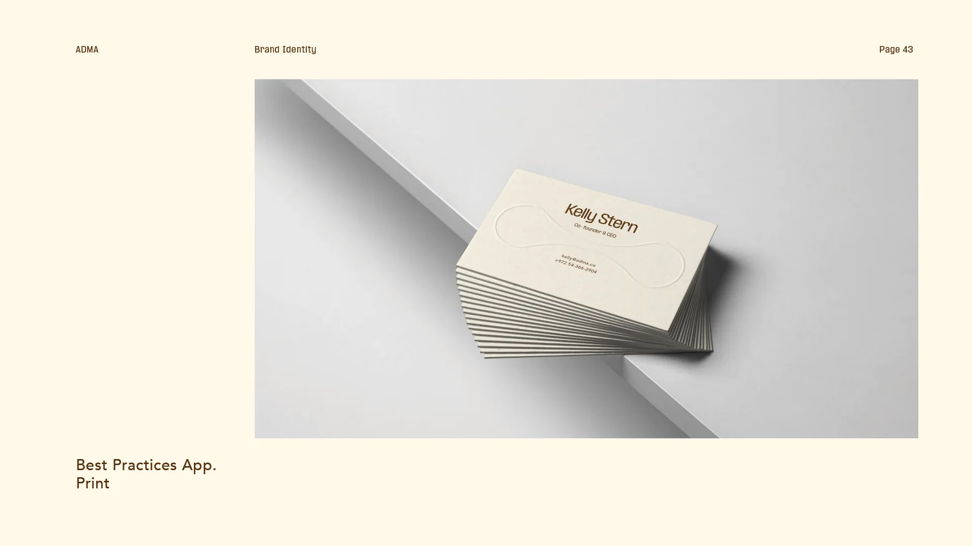 Stack of cream-colored business cards for Kelly Stern, Co-Founder & CEO, placed on a white surface with embossed abstract design.