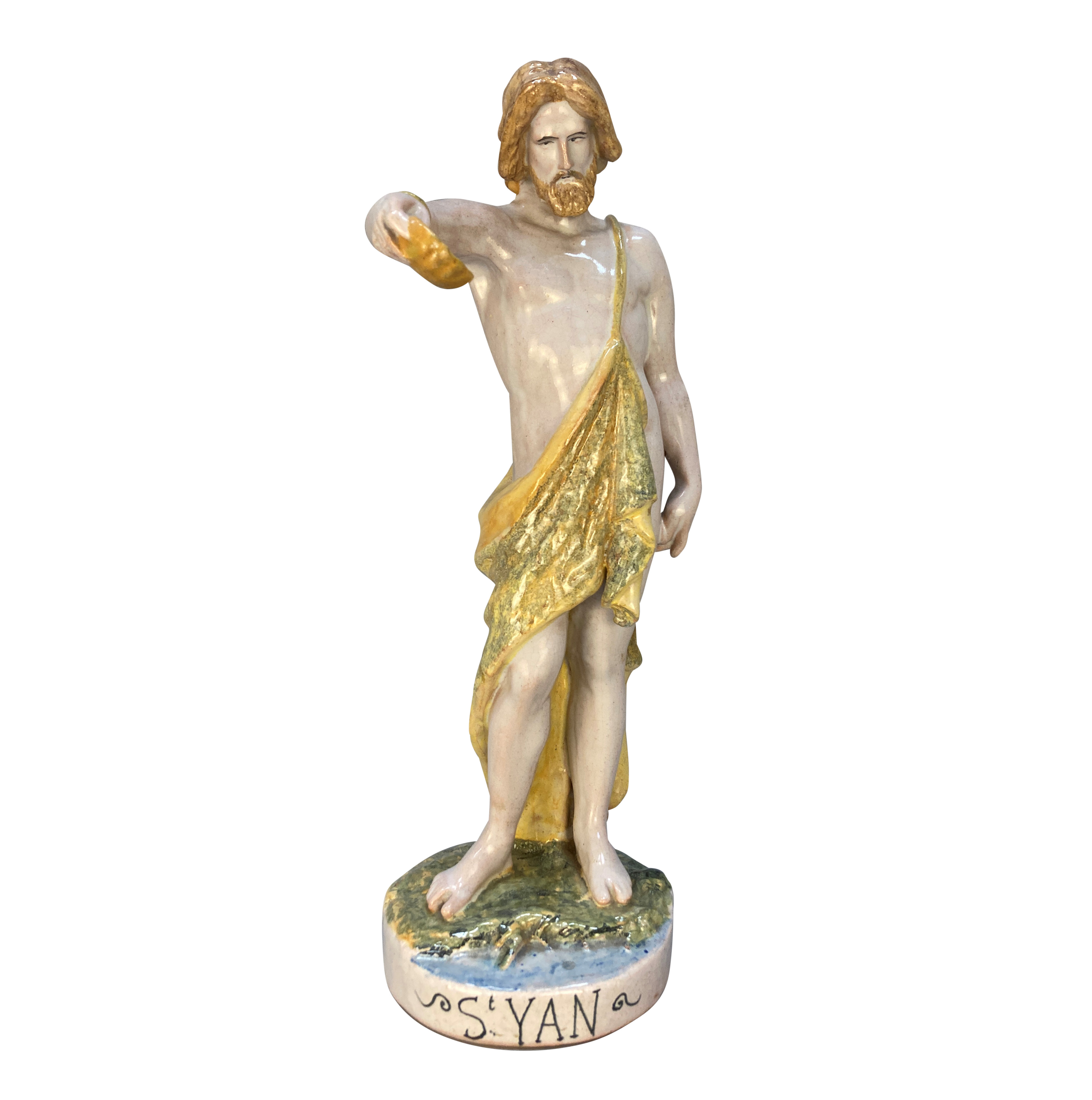 A SPANISH MAJOLICA STATUE OF ST JOHN THE BAPTIST