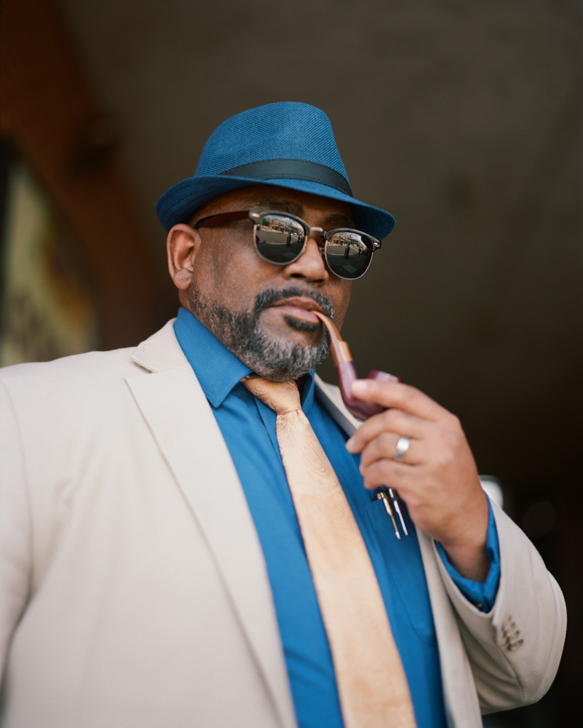 Man on Beale Street dressed fashionably smoking a cigar