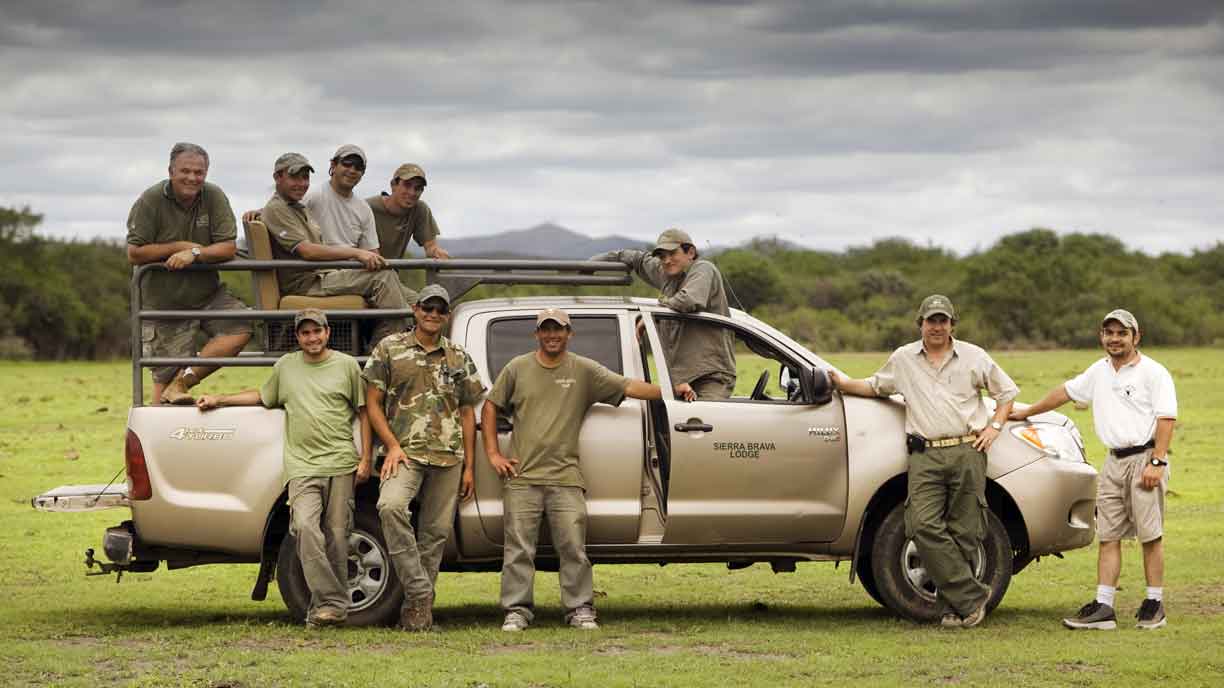 Hunting party with guides beside the pickup in the dove field