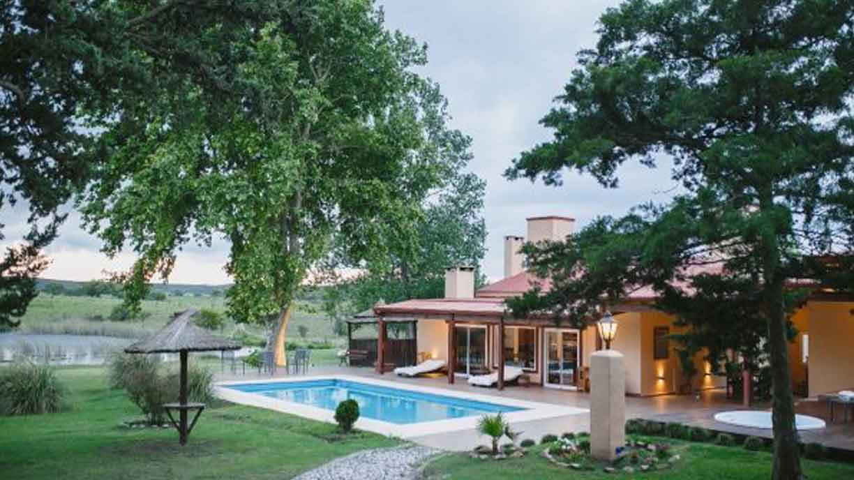 Lodge grounds and pool framed by tall trees