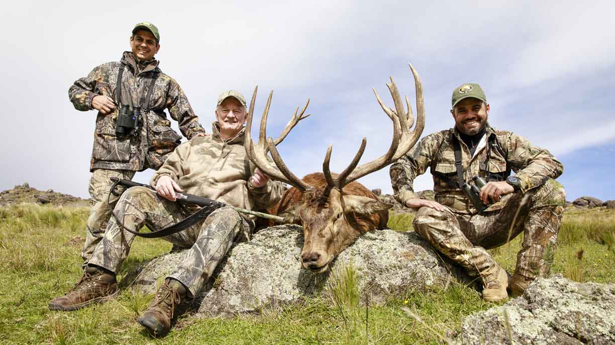 Hunters with a trophy red stag in Argentina