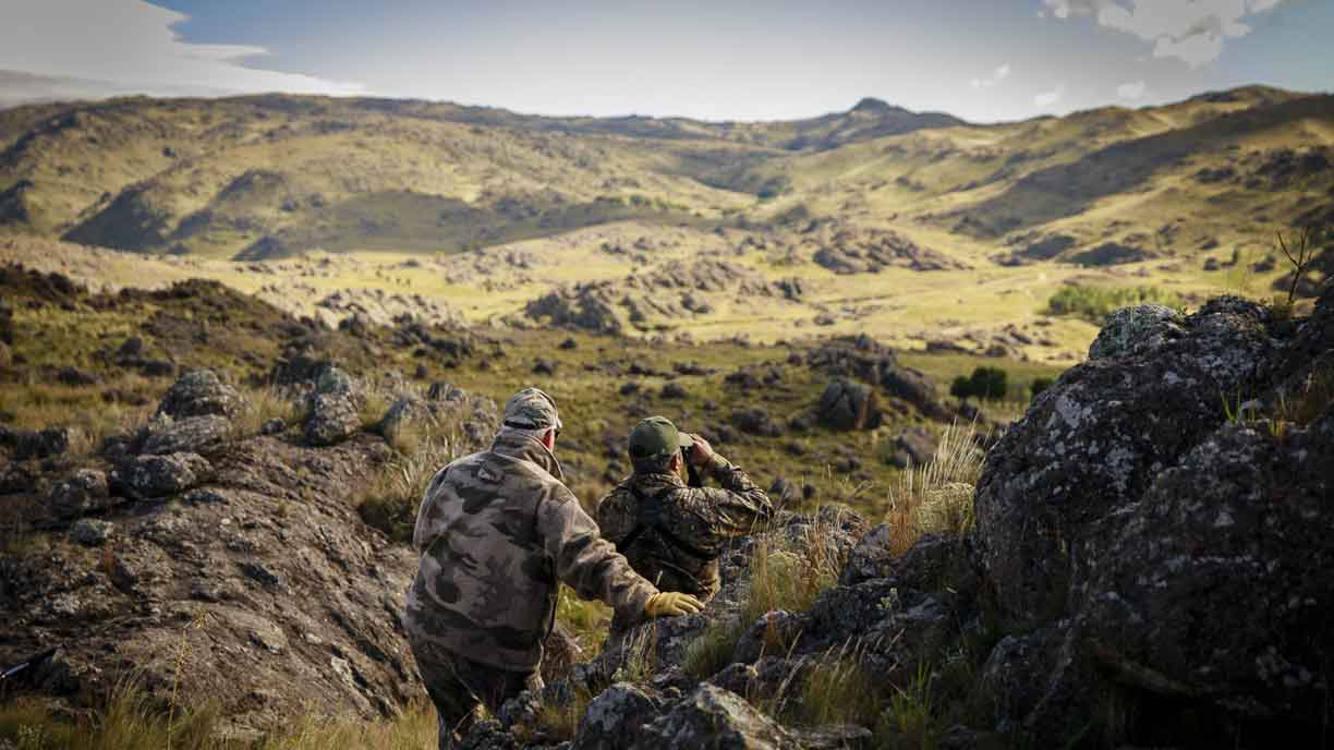 Hunters stalking through the hills on a big game hunt