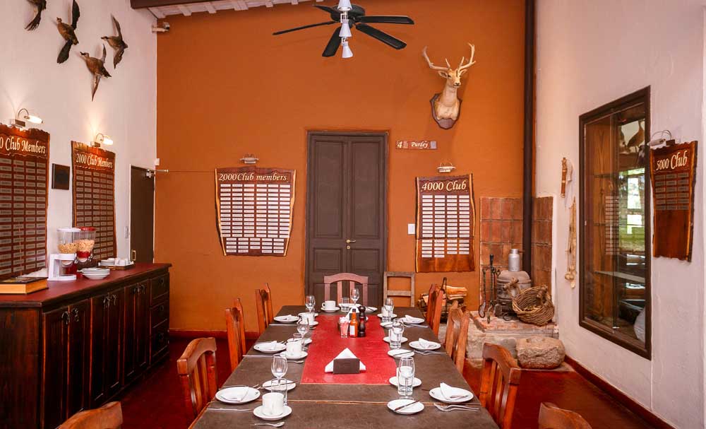 Dining area with a long table and colonial decor