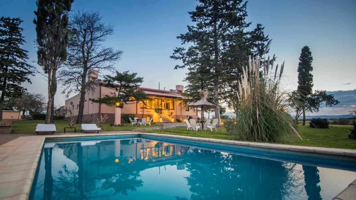Pool house and swimming pool in the afternoon sun