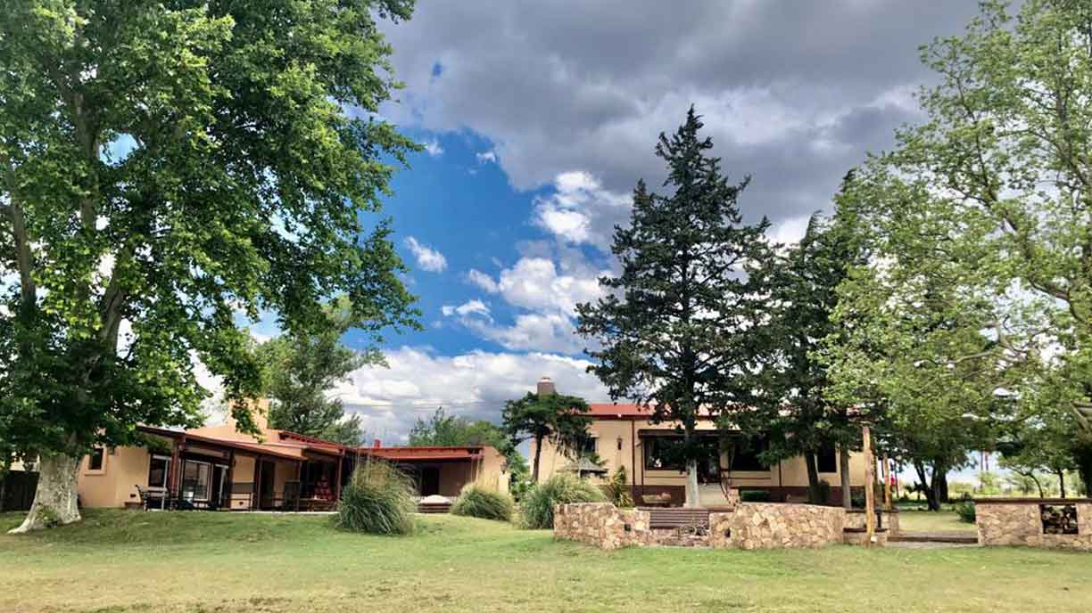 Front of the estancia surrounded by trees