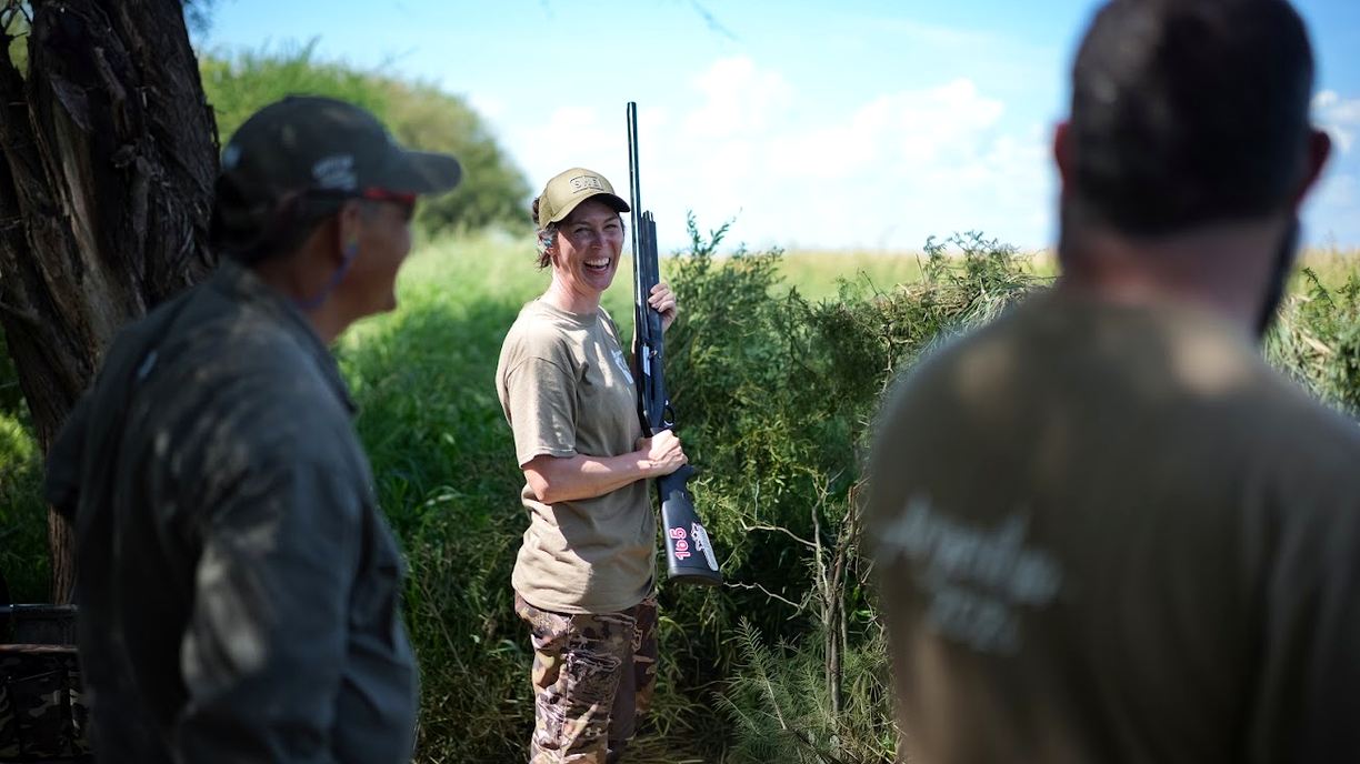 Smiling guest with a shotgun on a dove hunt