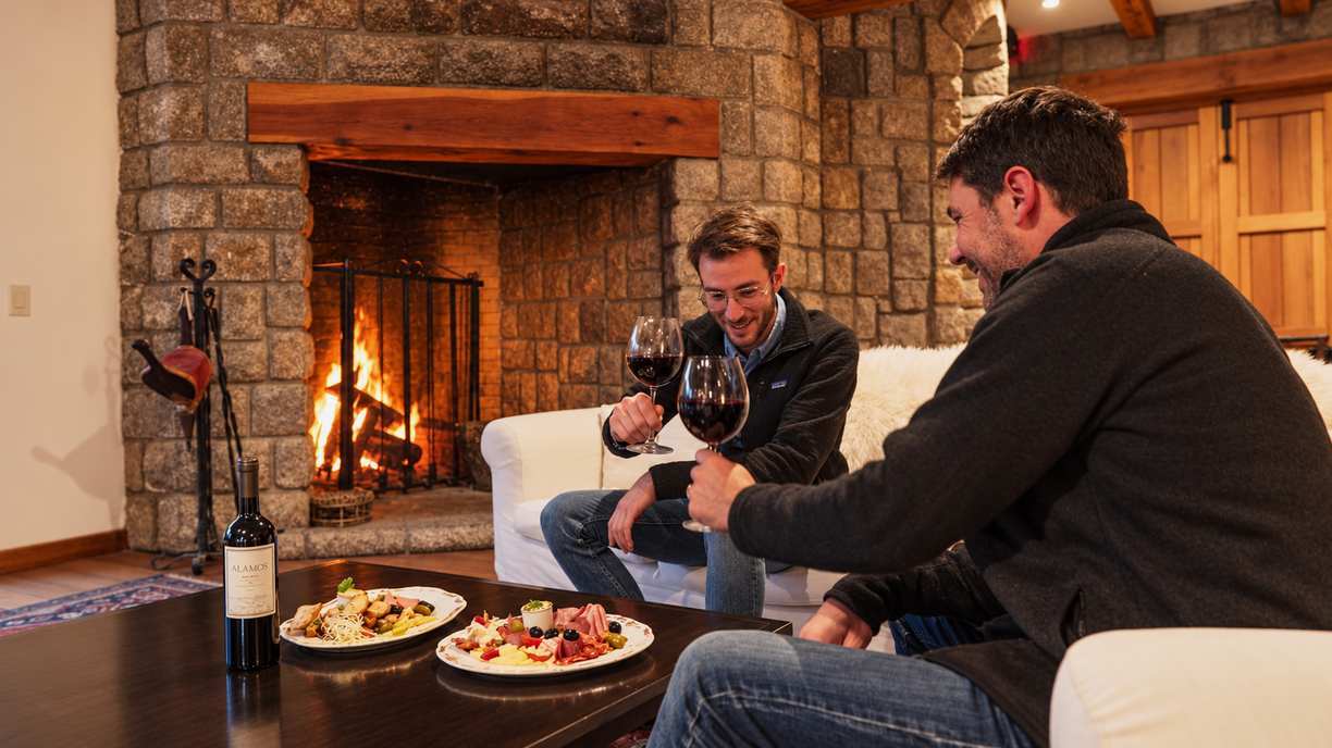 Toast by the fireplace at Bravo Sur Lodge