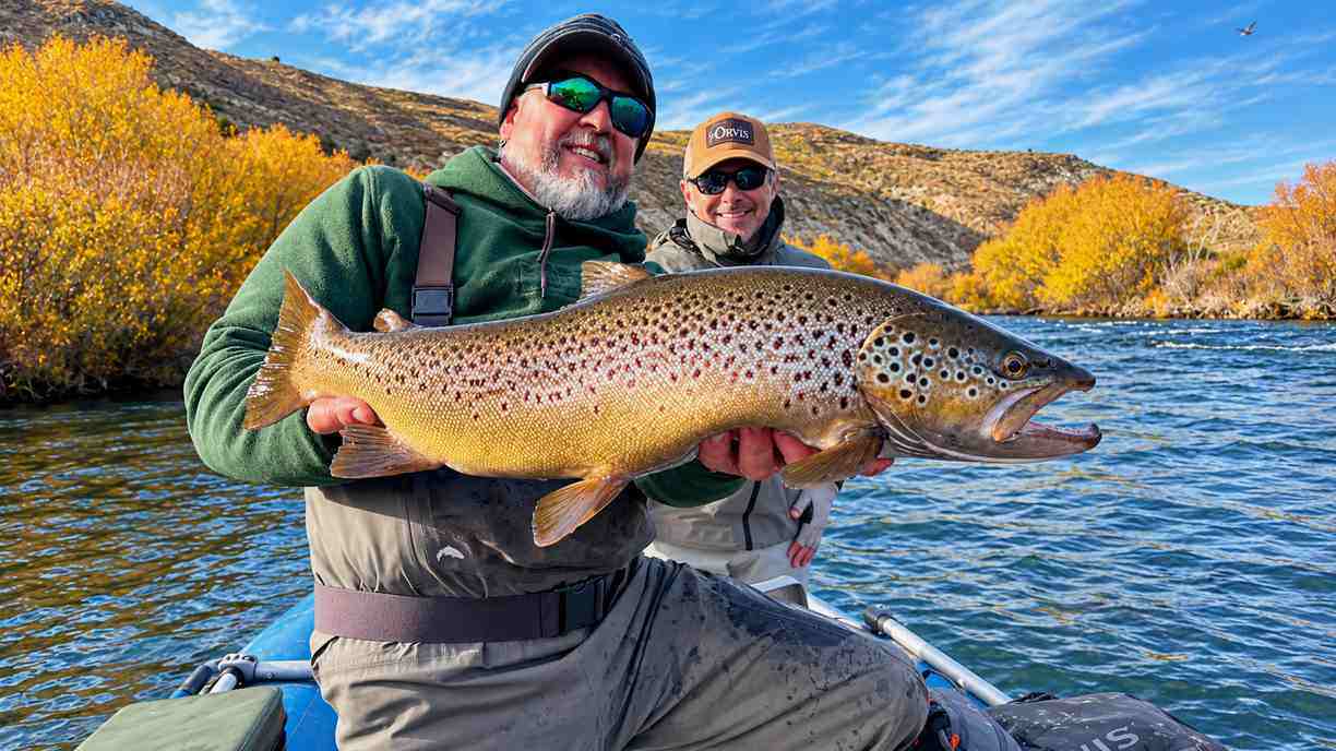 Guide and angler with a brown trout near Bravo Sur Lodge