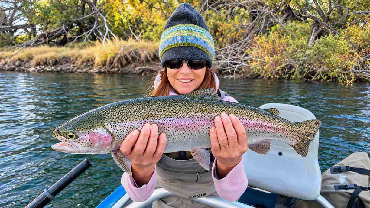 Angler holding a rainbow trout near Bravo Sur Lodge