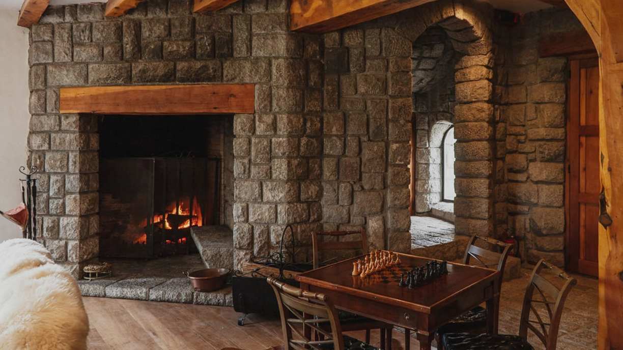 Fireplace room with chess table at Bravo Sur Lodge