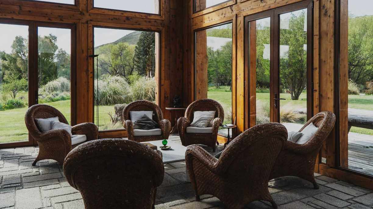 Lounge with large windows at Bravo Sur Lodge