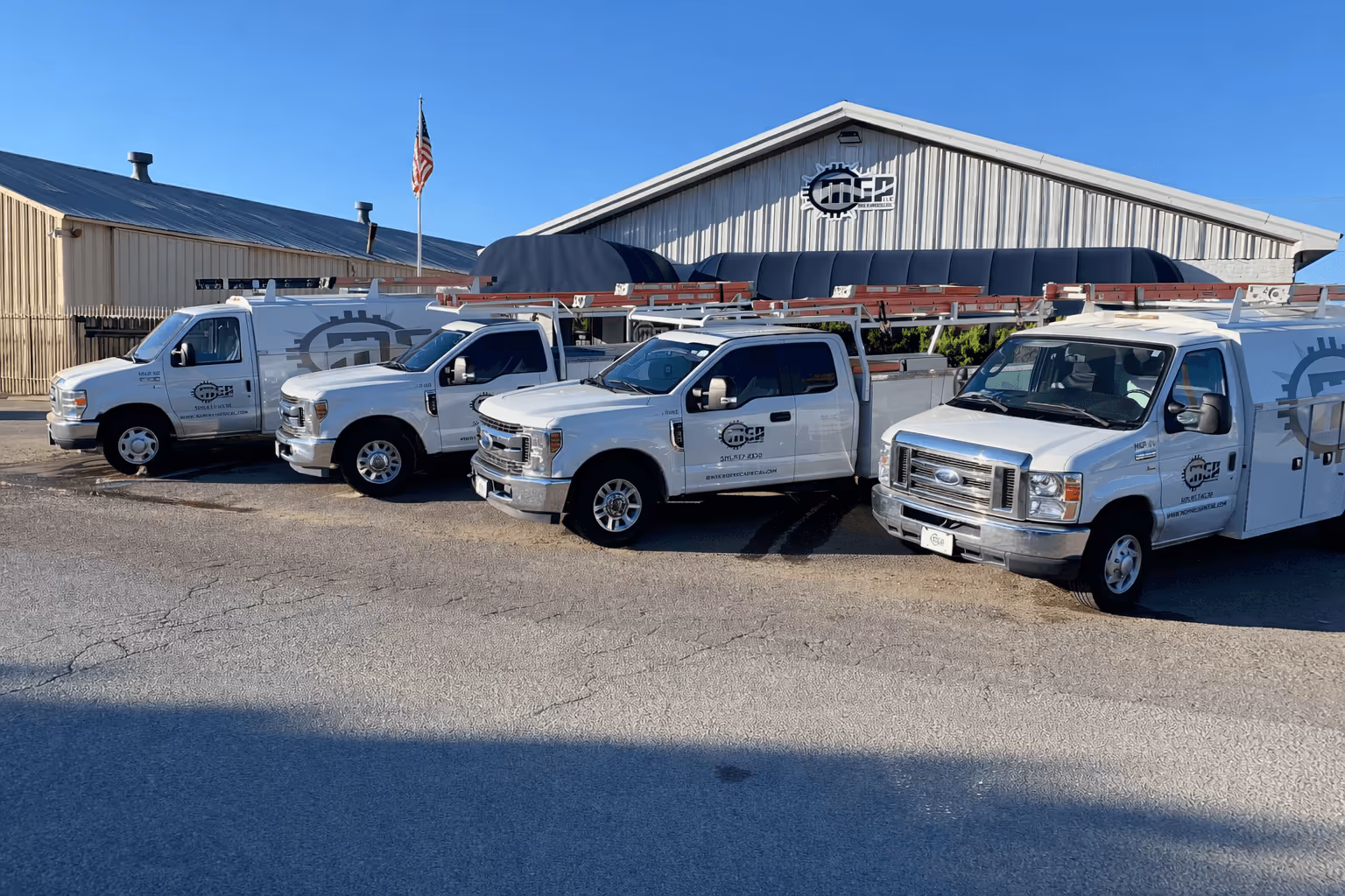 MGP Mechanical team standing with service vans in front of their Albuquerque shop