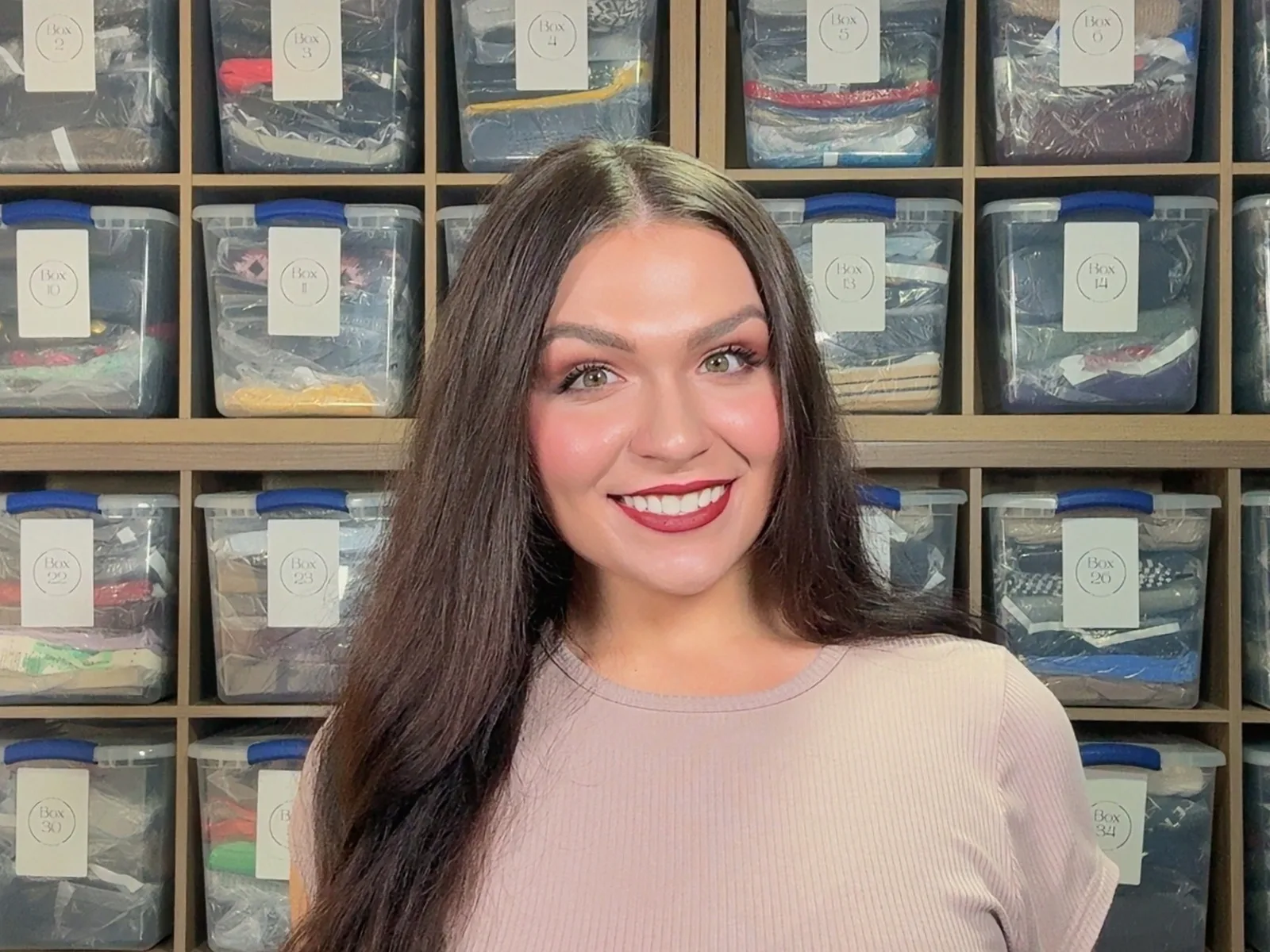 Giada Lynne Pernice in front of her wall of labeled inventory bins