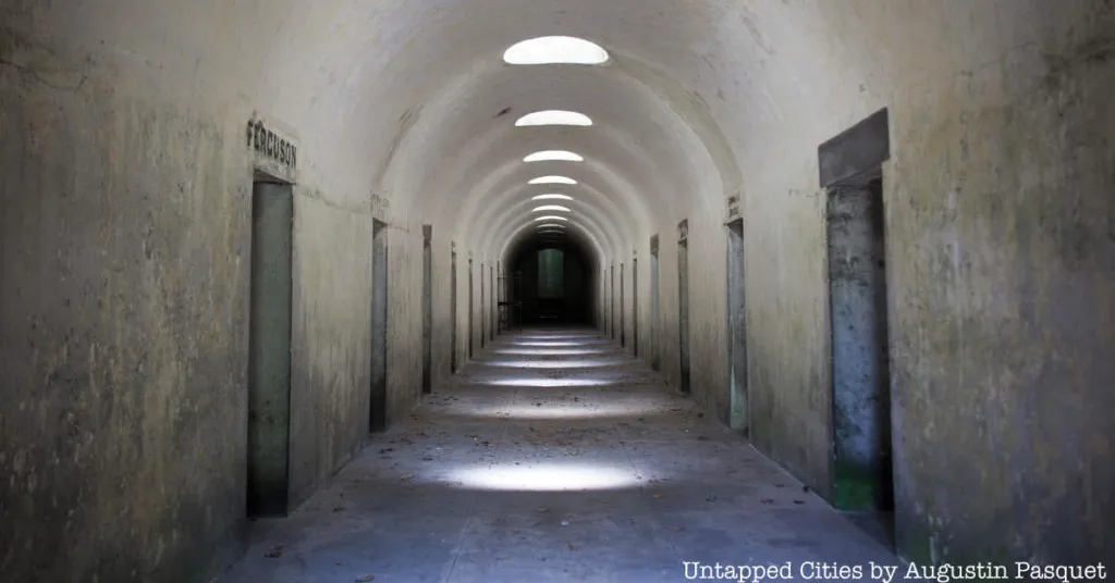 Black and white image of catacomb hallway.