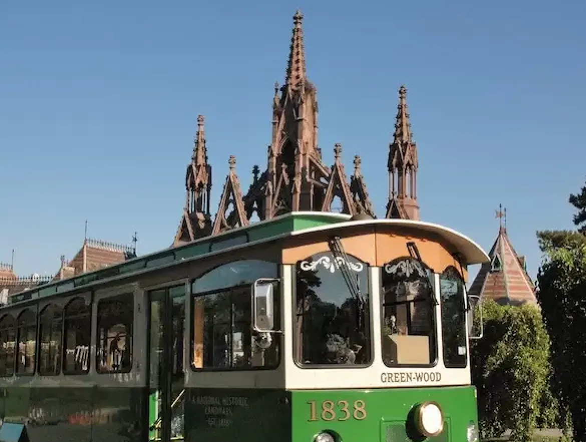 A vintage trolley in front of Green-Wood's monumental gothic gate.