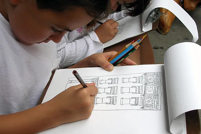 A photo of students sketching cast iron buildings in SoHo.