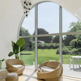 Photo of a modern interior looking out onto a green yard.