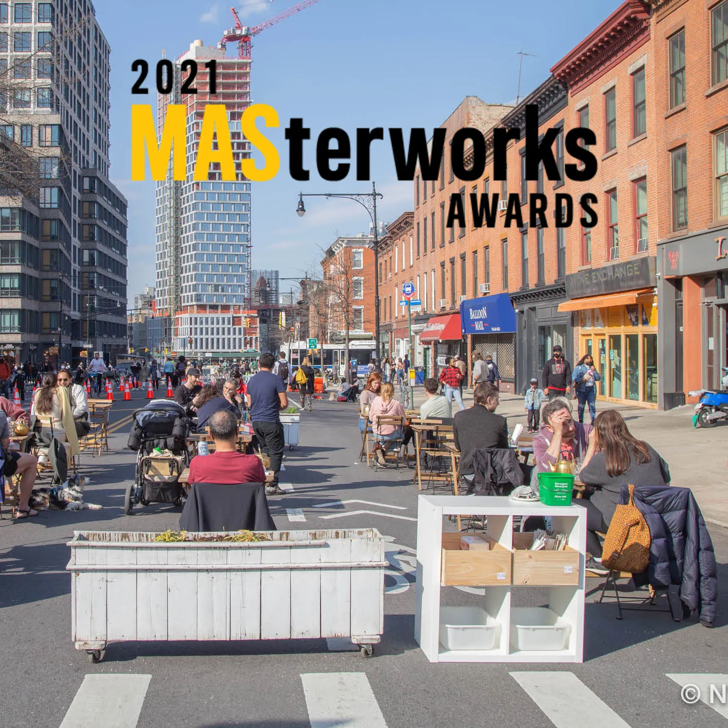Photo of an open street with restaurant seating space and pedestrians circulating, with the MASterworks Explorations logo superimposed over the image.