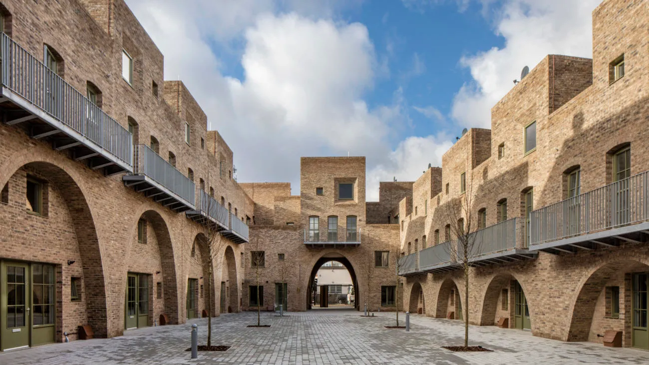 Image of the inner courtyard of a light brick 2 story building.