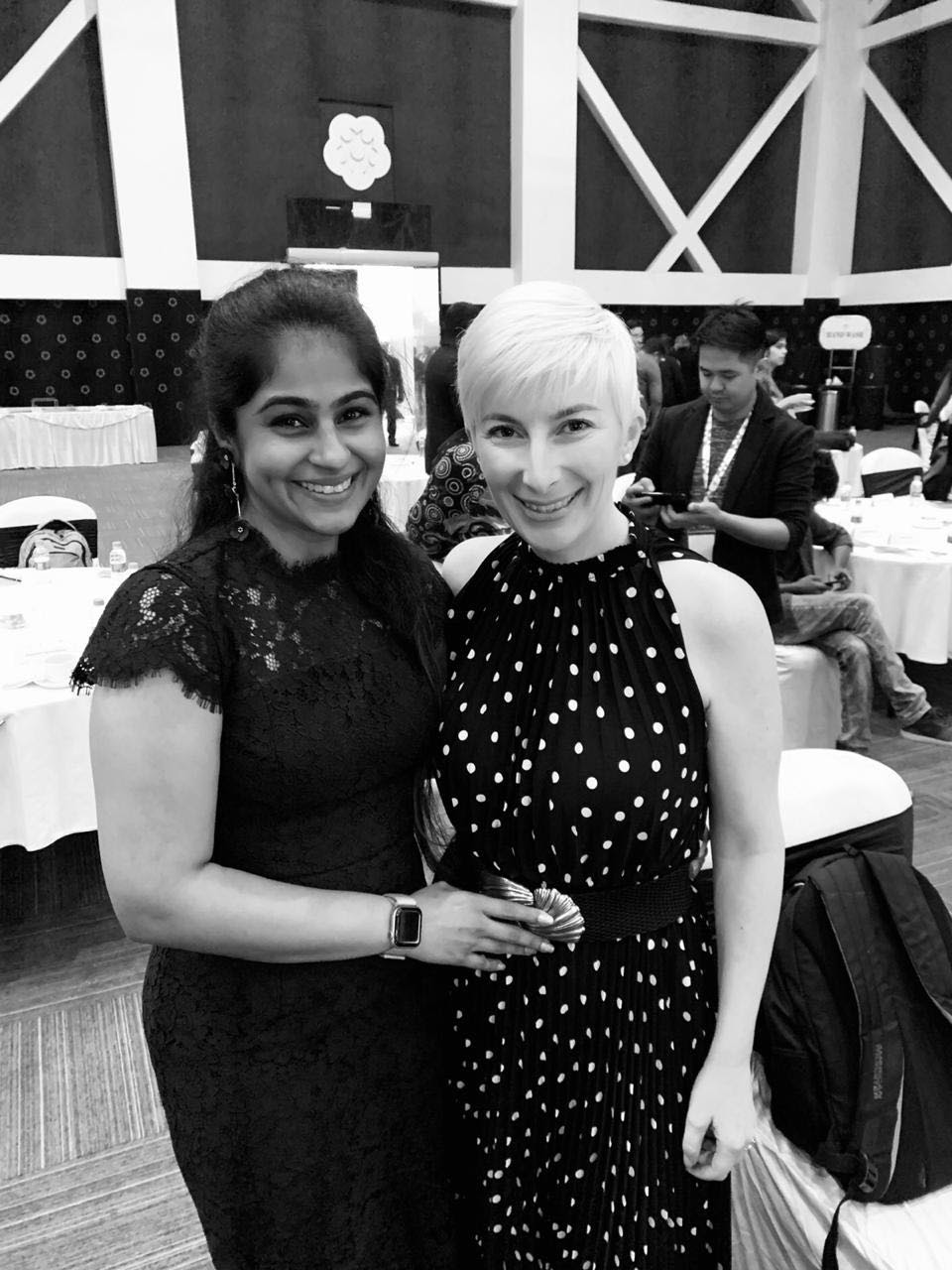 two happy women standing in an event