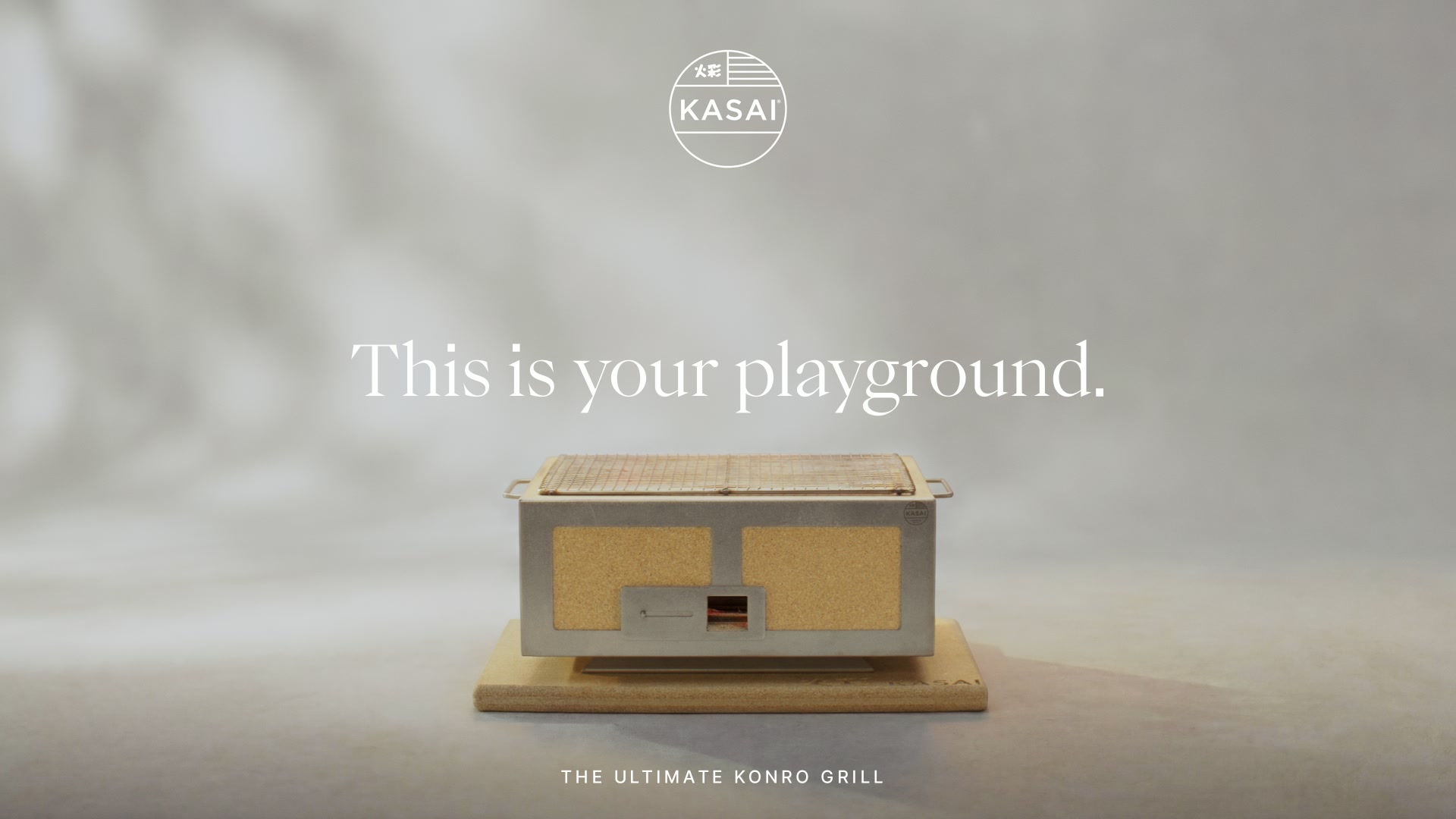 Kasai Konro grill on pale base, grey backdrop, Kasai logo top; headline This is your playground; strapline The Ultimate Konro Grill.