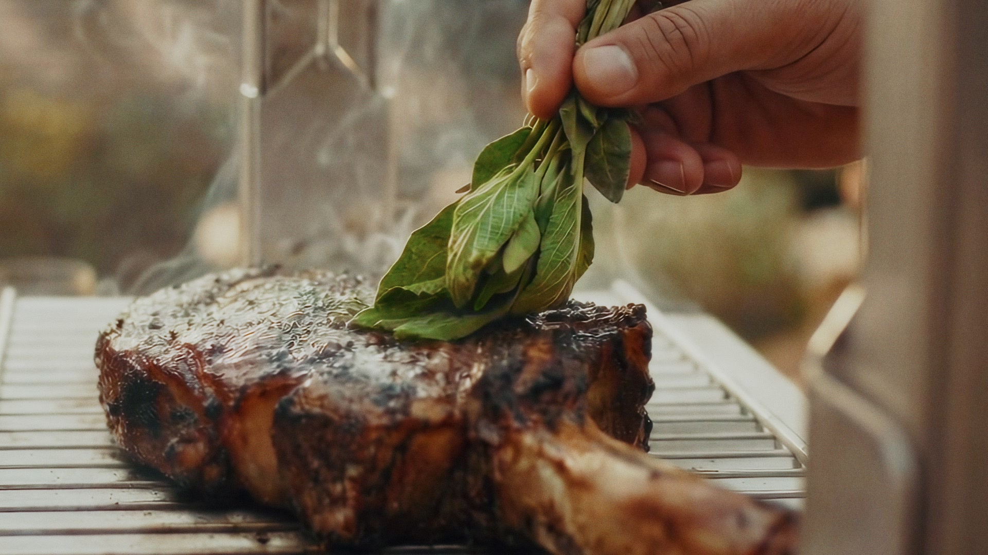 Man in yellow shirt adjusting four king-prawn skewers on a Kasai Konro grill branded KASAI JAPANESE GRILL.