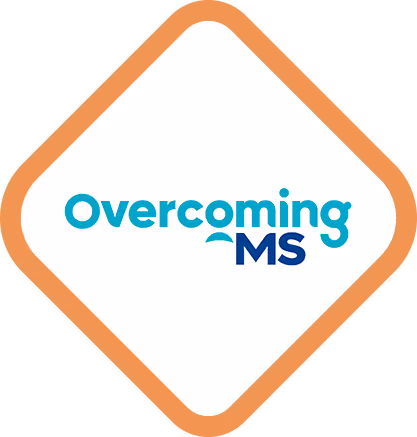 Overcoming MS logo in teal and dark blue text, with the word “Overcoming” in teal and “MS” in dark blue, featuring a curved underline beneath the “o” and “M”.