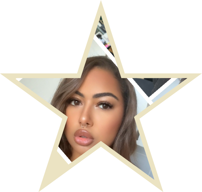 Shani is looking off confident with her arms on her sides in a black dress