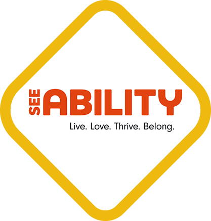 SeeAbility logo inside a rounded yellow diamond border with the words ‘SEE ABILITY’ in orange and the tagline ‘Live. Love. Thrive. Belong.’ underneath