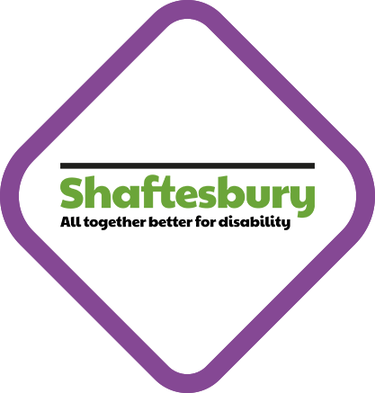 ogo for Variety, the Children’s Charity, featuring a red heart wearing a white top hat, next to the word ‘variety’ in bold black letters and the tagline ‘the children’s charity’ in red lowercase text, all within a purple diamond-shaped border.