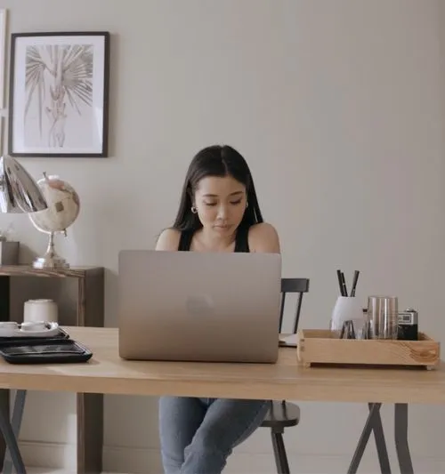 A person sitting at a desk with a laptop