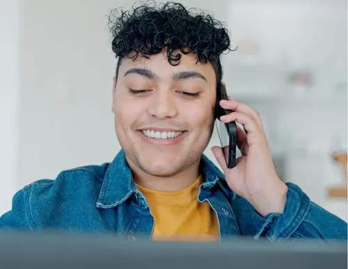 A person holding a phone to his ear