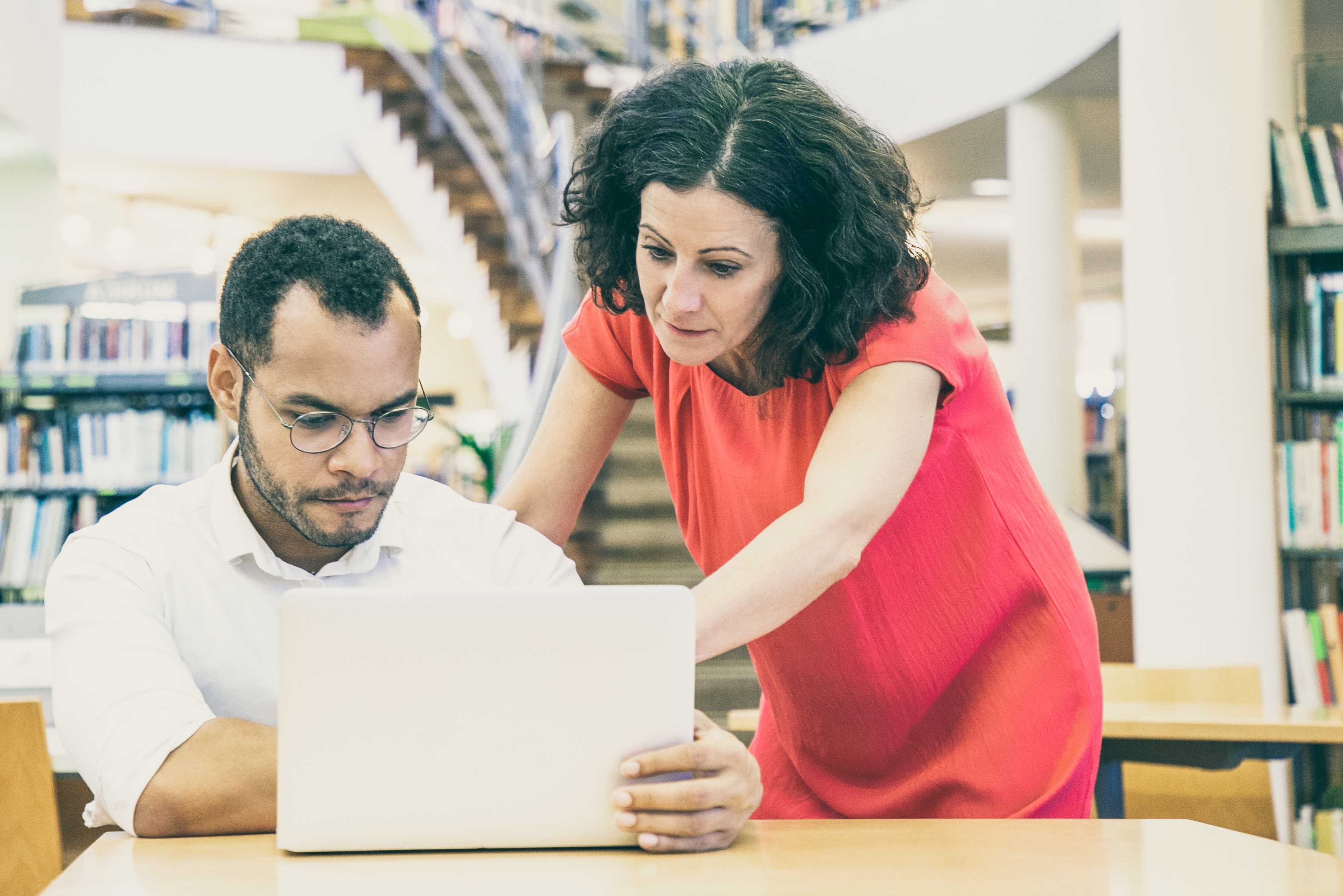woman and man looking at laptop together