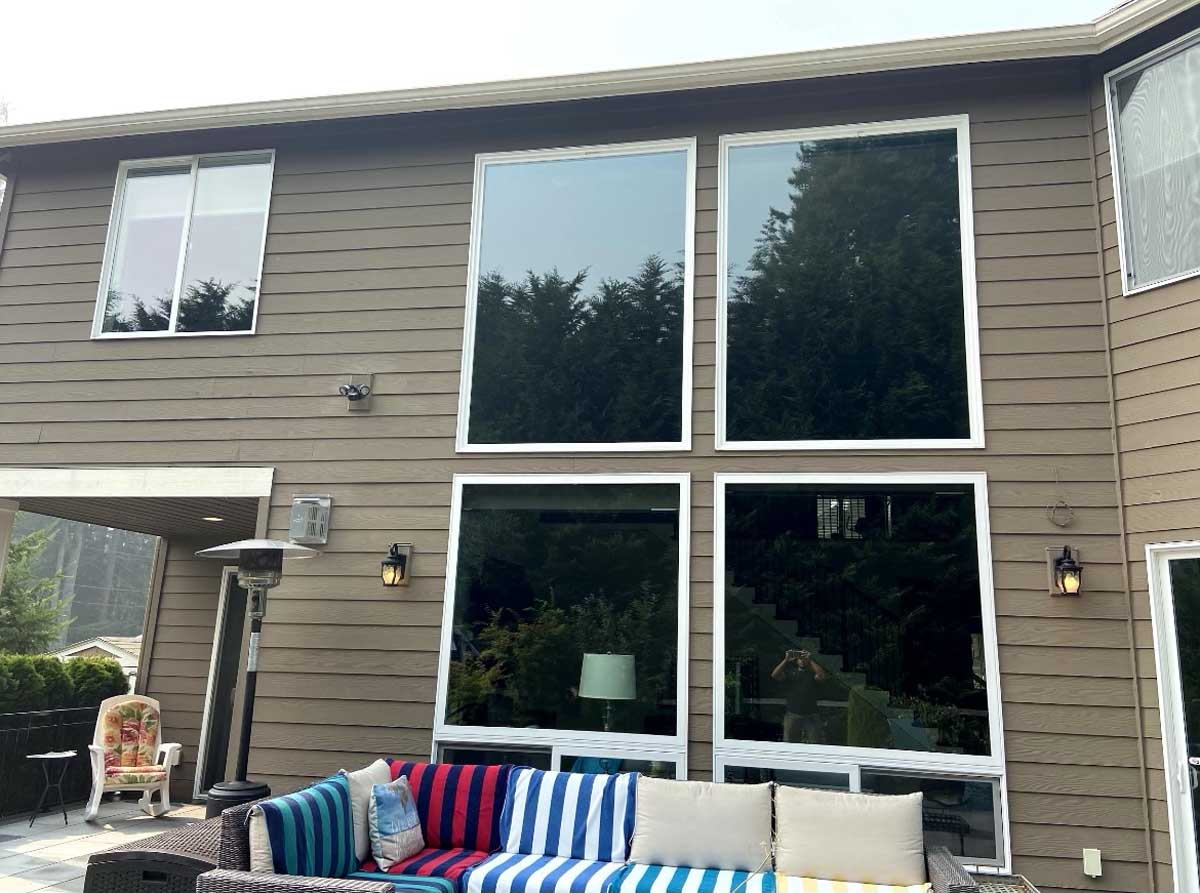 Home exterior with several large, clean windows.