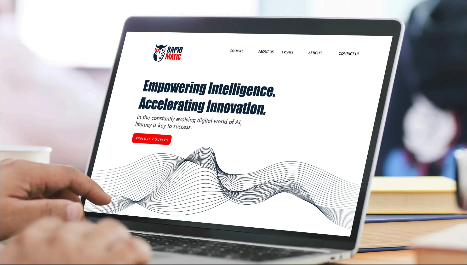 Laptop displaying a modern website design with navigation, text, and graphic elements.