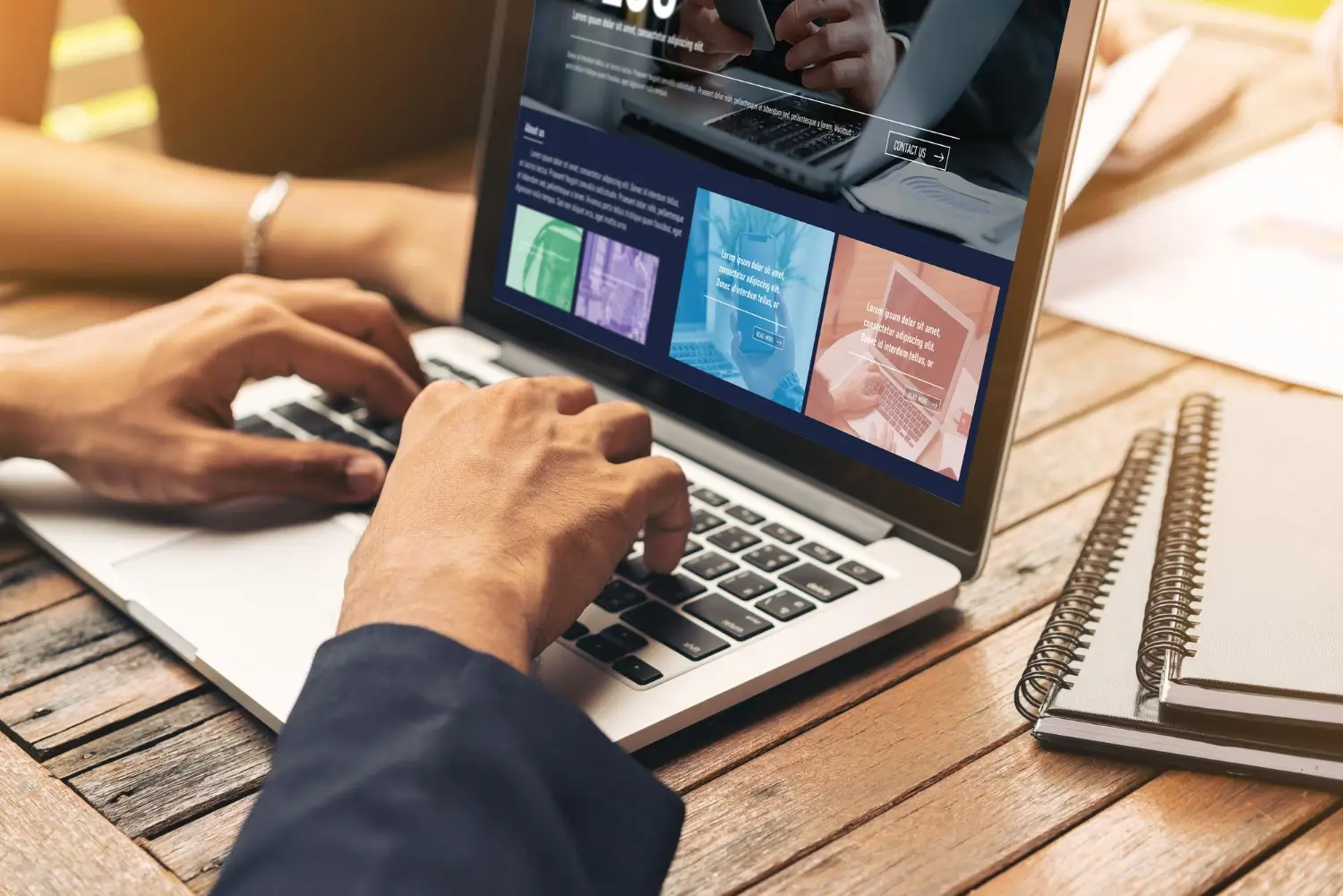 Developer working on a website layout displayed on a laptop.