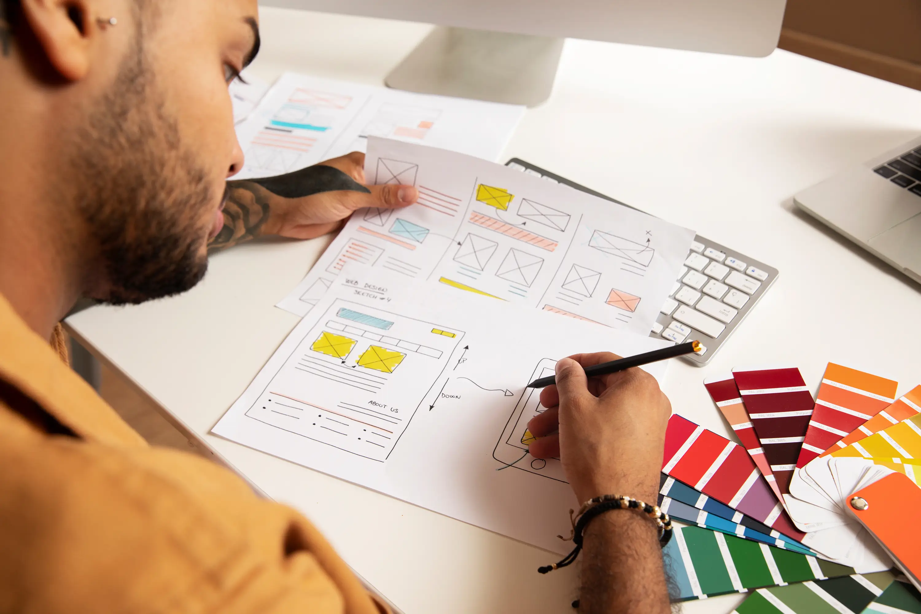 UI/UX design process with website wireframes, color palettes, and interface concepts